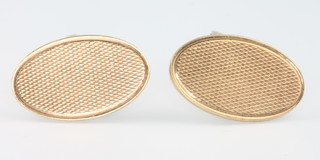 A pair of 9ct yellow gold oval engine turned cufflinks 9.4 grams 
