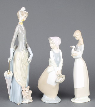 A Nao figure of a girl with basket 10", ditto with goose 11" and a Lladro lady with parasol 14" 