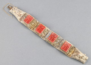 A Chinese silver gilt bracelet with carved coral plaques