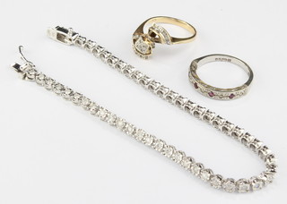 A 9ct white gold diamond tennis bracelet 7" and 2 diamond set rings size K and L 