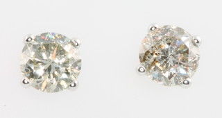 A pair of 14ct white gold diamond ear studs, in total 1.25ct 