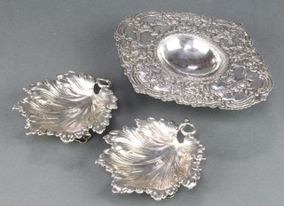 A pair of Continental leaf shaped dishes 4 1/4" together with a quatrefoil ditto with repousse floral decoration 7", 274 grams 
