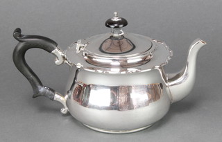 A silver baluster teapot with fancy rim and ebonised mounts Birmingham 1927, gross weight 324 grams