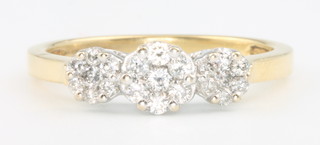 A yellow gold diamond triple cluster ring, size R