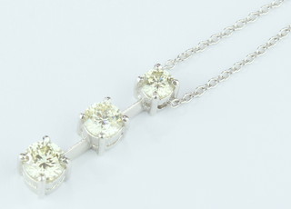 A white gold three stone diamond 0.70 ct drop pendant on an 18ct white gold chain
