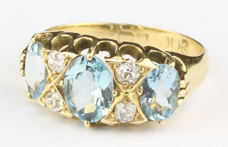 An 18ct yellow gold aquamarine and diamond ring size L