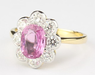 An 18ct yellow gold oval pink sapphire 1.25ct and 8 stone diamond 0.90ct ring size O