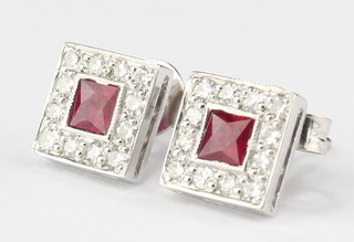 A pair of 18ct white gold square princess cut ruby and brilliant cut diamond ear studs