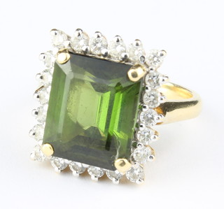 An 18ct yellow gold rectangular cut tourmaline and diamond surround ring, size J 