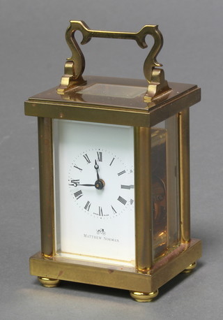 Matthew Norman, a 20th Century miniature carriage timepiece with enamelled dial and Roman numerals contained in a gilt metal case 3" x 2" x 1 1/2" 