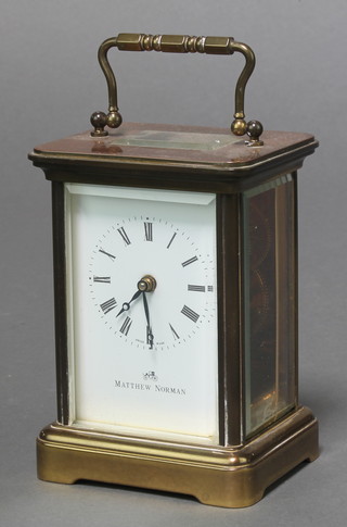 Matthew Norman, a 20th Century 8 day carriage timepiece with enamelled dial and Roman numerals contained in a gilt metal case 4 1/2"h x 2 1/2"w x 2"d 