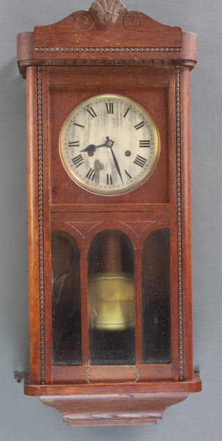 A 1930's chiming wall clock with 7" silvered dial and Arabic numerals contained in an oak case 