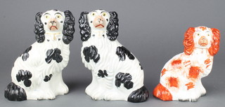 A pair of Victorian black and white Staffordshire Spaniels 7", a single ochre ditto 6"