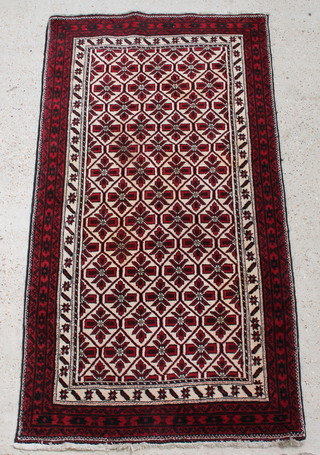 A red and white ground Turkoman rug with all-over geometric design within multi row borders 74 1/2" x 39 1/2" 