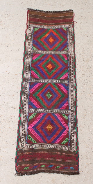 A multicoloured Suzmi Kilim runner with 4 stylised diamond medallions to the centre 68" x 21" 