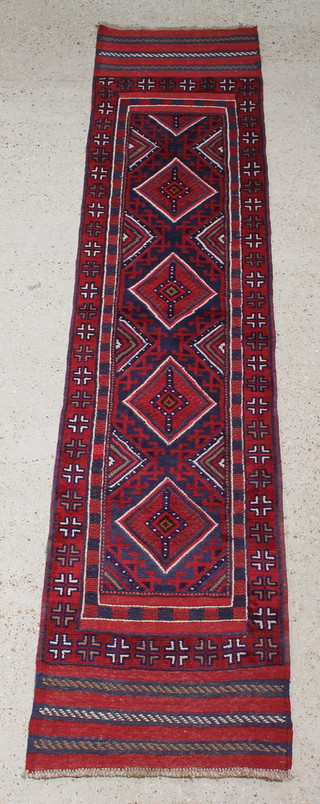 A red and white ground Meshwani runner with 4 stylised diamonds to the centre within a multi-row border 111" x 26" 