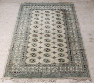 A white ground Bokhara carpet with 36 octagons to the centre 104" x 74" (some staining) 