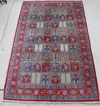 A Persian Qum carpet, the centre formed of 54 panels decorated with flowers 118" x 76"