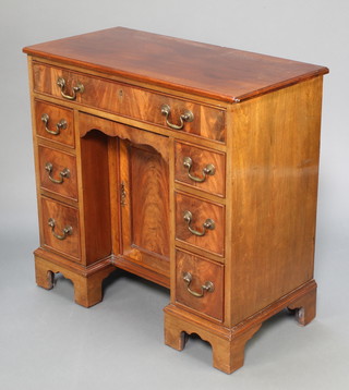 A Georgian style mahogany dressing table fitted 1 long drawer above a secret drawer, the pedestal fitted a cupboard flanked by 6 short drawers raised on bracket feet 28 1/2"h x 30"w x 14 1/2"d 
