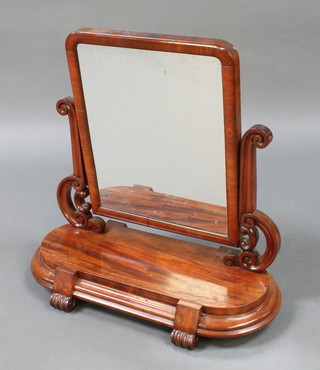A Victorian arch shaped plate dressing table mirror contained in a mahogany frame  on an oval base fitted a secret drawer with scroll feet 27"h x 28"w x 12"d 
