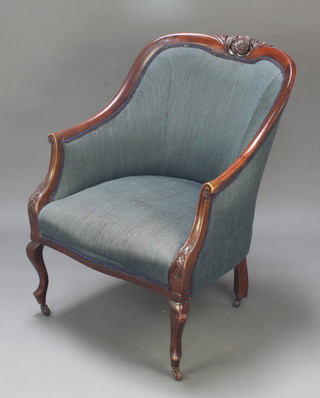 An Edwardian show frame carved mahogany tub back armchair upholstered in green material raised on cabriole supports  