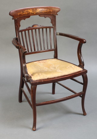 An Edwardian inlaid mahogany stick and rail back carver chair with upholstered seat raised on cabriole supports (f and r) 