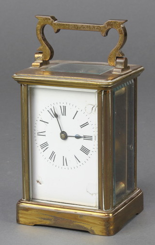 A French 8 day carriage timepiece with enamelled dial and Roman numerals contained in a gilt case 4 1/2" x 3" x 2" 