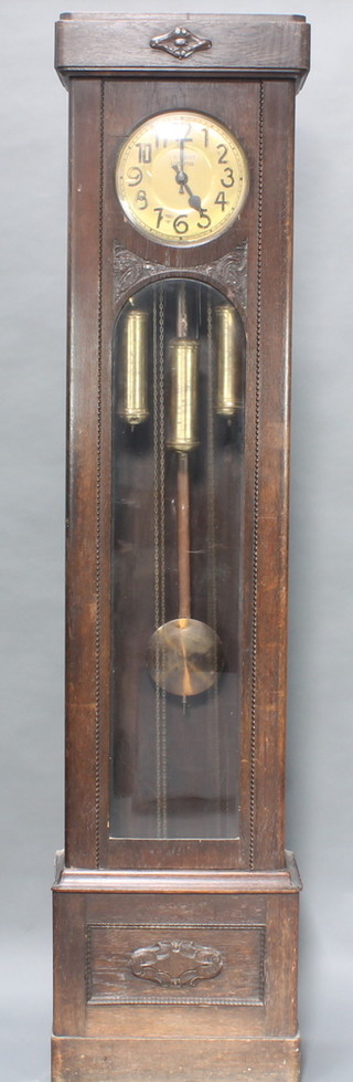 An Art Nouveau 8 day striking longcase clock, the 10 1/2" circular brass dial with Arabic numerals marked T H Perret of Liverpool, contained in an oak case 
