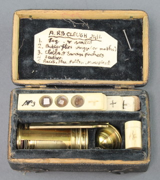 A 19th Century brass single pillar students field microscope 2" together with 5 ivory slides contained in a wooden case with hinged lid