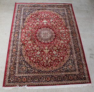 A red ground Kashan style carpet with central medallion 111" x 79" 