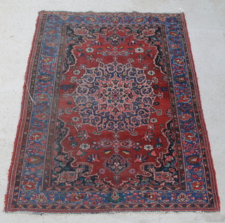 A red ground Persian rug with central medallion in multi row border 79" x 62" 