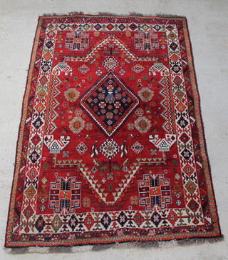 A red ground Afghan rug with diamond medallion to the centre 97" x 66" 