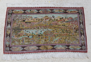 A fine silk rug decorated a landscape depicting a lake with a bridge, volcano in the distance and animals 30 1/2" x 49" 