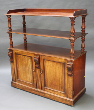 A Victorian mahogany 2 tier buffet with raised back and three-quarter gallery raised on turned supports, the base fitted a cupboard with cellarette drawer enclosed by panelled doors 52"h x 47"w x 17 1/2"d  