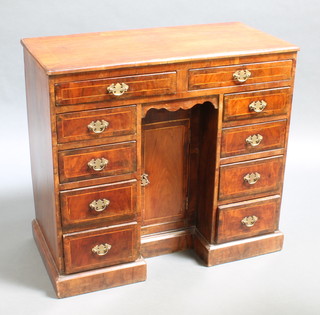 A Georgian mahogany and crossbanded dressing table inlaid satinwood stringing, fitted 2 short and 8 long drawers, the pedestal fitted a cupboard enclosed by a panelled door 31"h x 34"w x 17" 