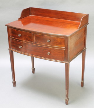 An Edwardian mahogany bow front wash stand with three-quarter gallery fitted 2 short drawers above 1 long drawer, raised on square tapering supports, spade feet 31"h x 30"w x 19"d 