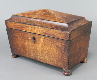 A William IV rosewood twin compartment tea caddy of sarcophagus form, the hinged lid revealing 2 caddies and a glass mixing/sugar bowl, raised on bun feet 8"h x 12"w x 6 1/2"d  