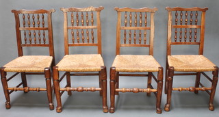 A matched set of 4 elm Lancashire spindle back dining chairs with rush seats 