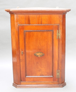 A Georgian mahogany  corner cabinet with moulded cornice, fitted shelves enclosed by a panelled door with brass H framed hinges 38"h x 30"w x 18 1/2"d 
