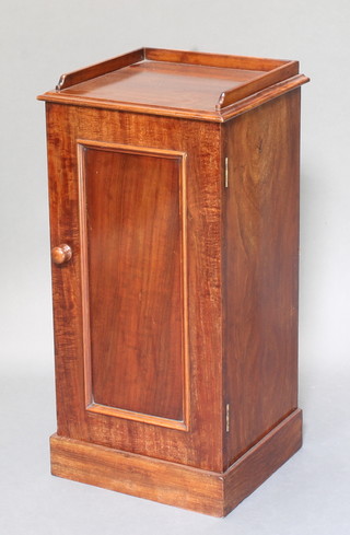 Heal & Sons of London, a Victorian mahogany pot cupboard with three-quarter gallery enclosed by a panelled door, raised on a platform base 30"h x 15"w x 14"d 