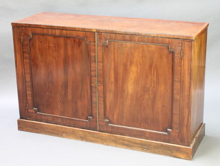 A 19th Century mahogany cabinet with shelved interior and crossbanded top, enclosed by panelled doors raised on a platform base 33"h x 51"w x 16"d 