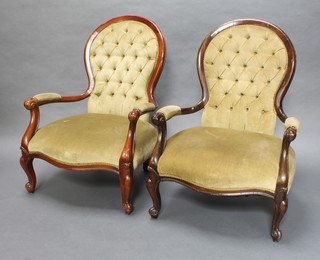 A matched pair of Victorian style beech framed open arm chairs upholstered in green buttoned material, raised on cabriole supports
