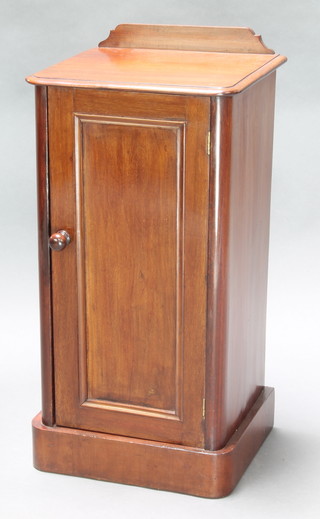 A Victorian mahogany pot cupboard with raised back enclosed by a panelled door, raised on a platform base 31"h x 15 1/2"w x 13"d 
