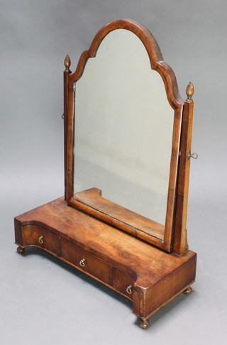 A Queen Anne style arch plate dressing table mirror contained in a walnut swing frame, the concaved shaped base fitted 1 long and 2 short drawers raised on bun feet 31"h x 22"w x 9 1/2"d 