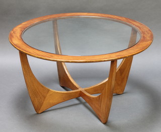 A 1960's G Plan circular Astro coffee table with plate glass top, raised on splayed supports with X framed stretcher 18"h x 33" diam. 