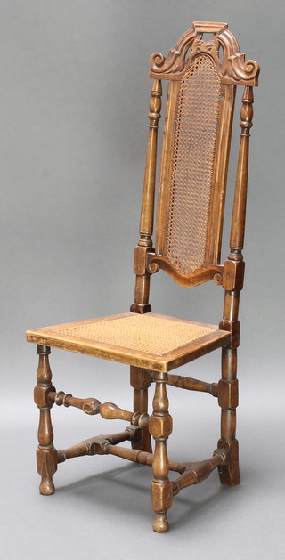 A Carolean style carved walnut high back chair with woven cane seat and back, raised on turned and block supports 