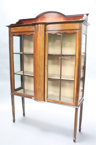 An Edwardian inlaid mahogany display cabinet with raised back, fitted shelves enclosed by astragal glazed panelled doors, raised on square tapered supports, spade feet 68"h x 45"w x 13"d 