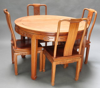 A Chinese circular carved Padouk wood extending dining table with carved apron raised on 4 club supports 30"h x 46" diam. (no leaves) together with 4 matching slat back dining chairs 

