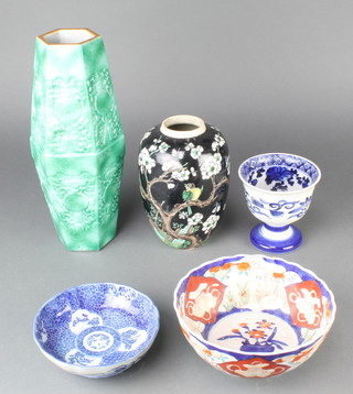 A Chinese oviform vase with black ground decorated with birds amongst flowering peony 8", an Imari bowl, a blue and white dish, a pedestal blue and white cup and a Chinese hexagonal turquoise glazed vase 12"  