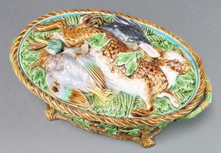 A Victorian Minton Majolica oval game pie dish and cover, the lid decorated with a hare, swallow and blackbird, the basket weave base with acorn decoration and twin handles. Pattern 899, 13"w